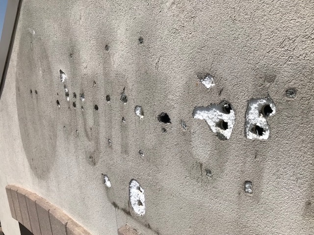 Close-up of anchor blowouts in EIFS substrate from removed signage