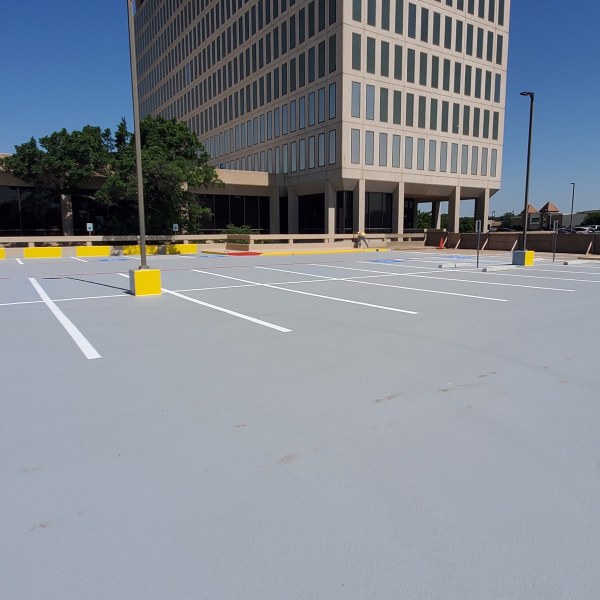 Parking deck coating completed in front of high-rise office tower